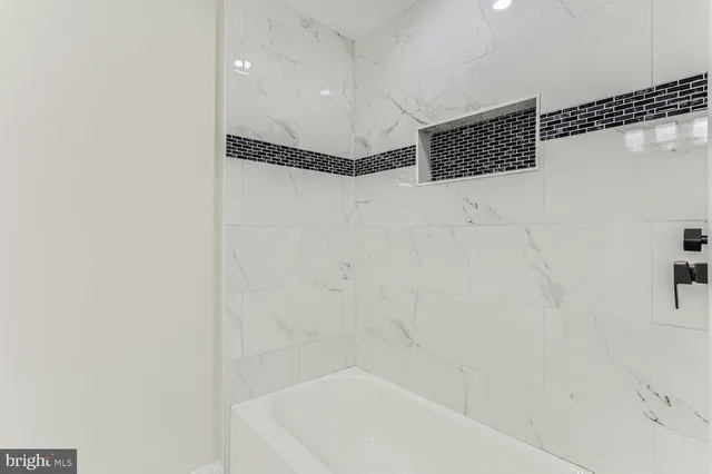 a bathroom with a bathtub and shower