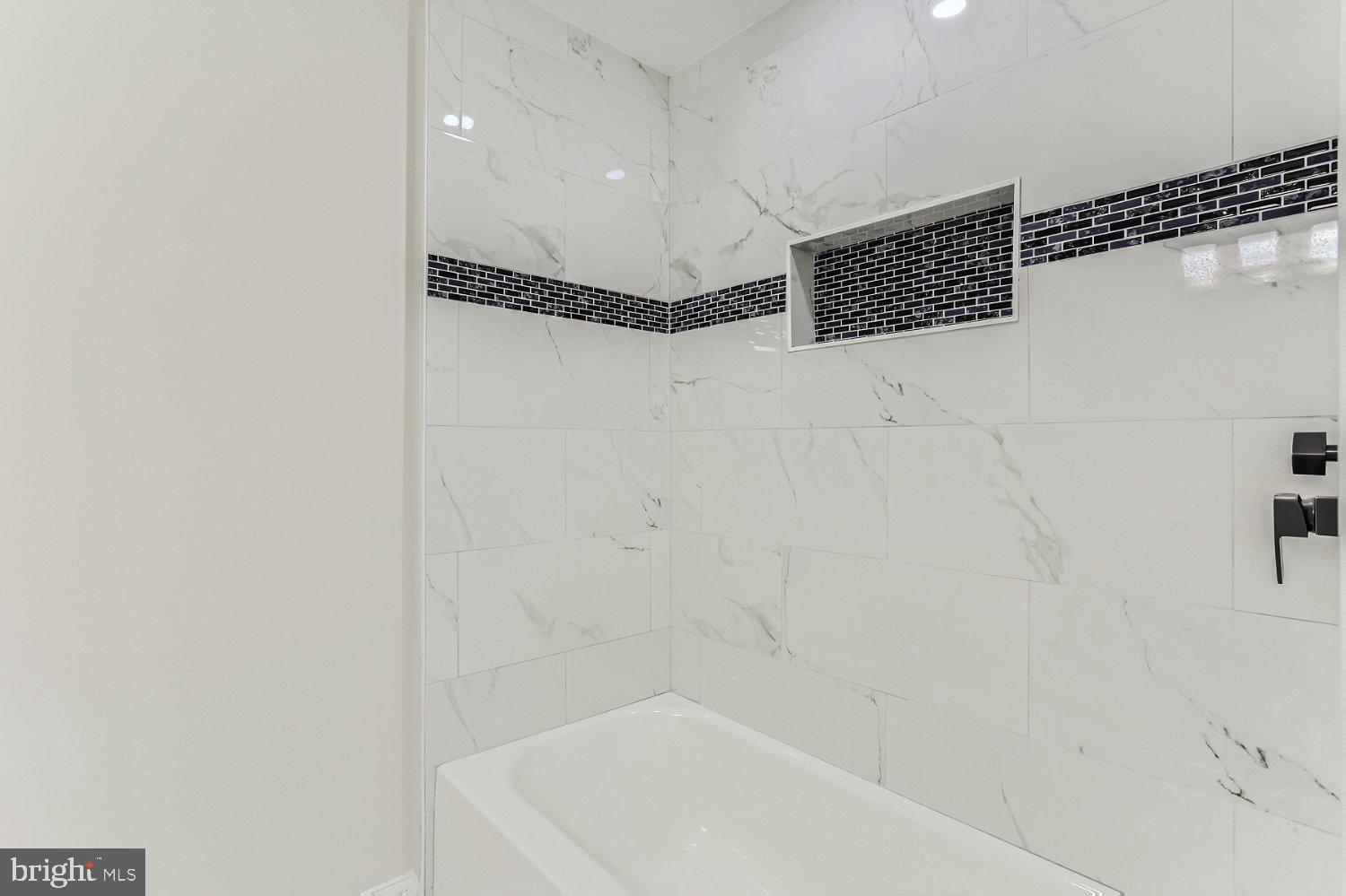 2829 Miles Avenue Baltimore, MD 21211 - Photo 17 of 25 a bathroom with a bathtub and shower