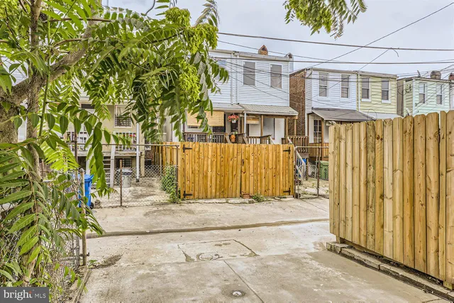 a front view of a house with a tree