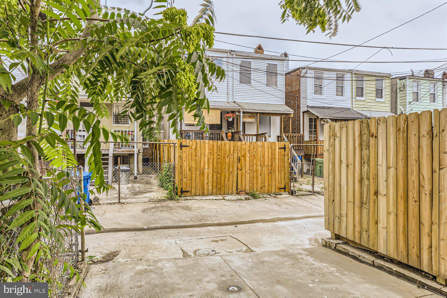 2829 Miles Avenue Baltimore, MD 21211 - Photo 21 of 25 a front view of a house with a tree