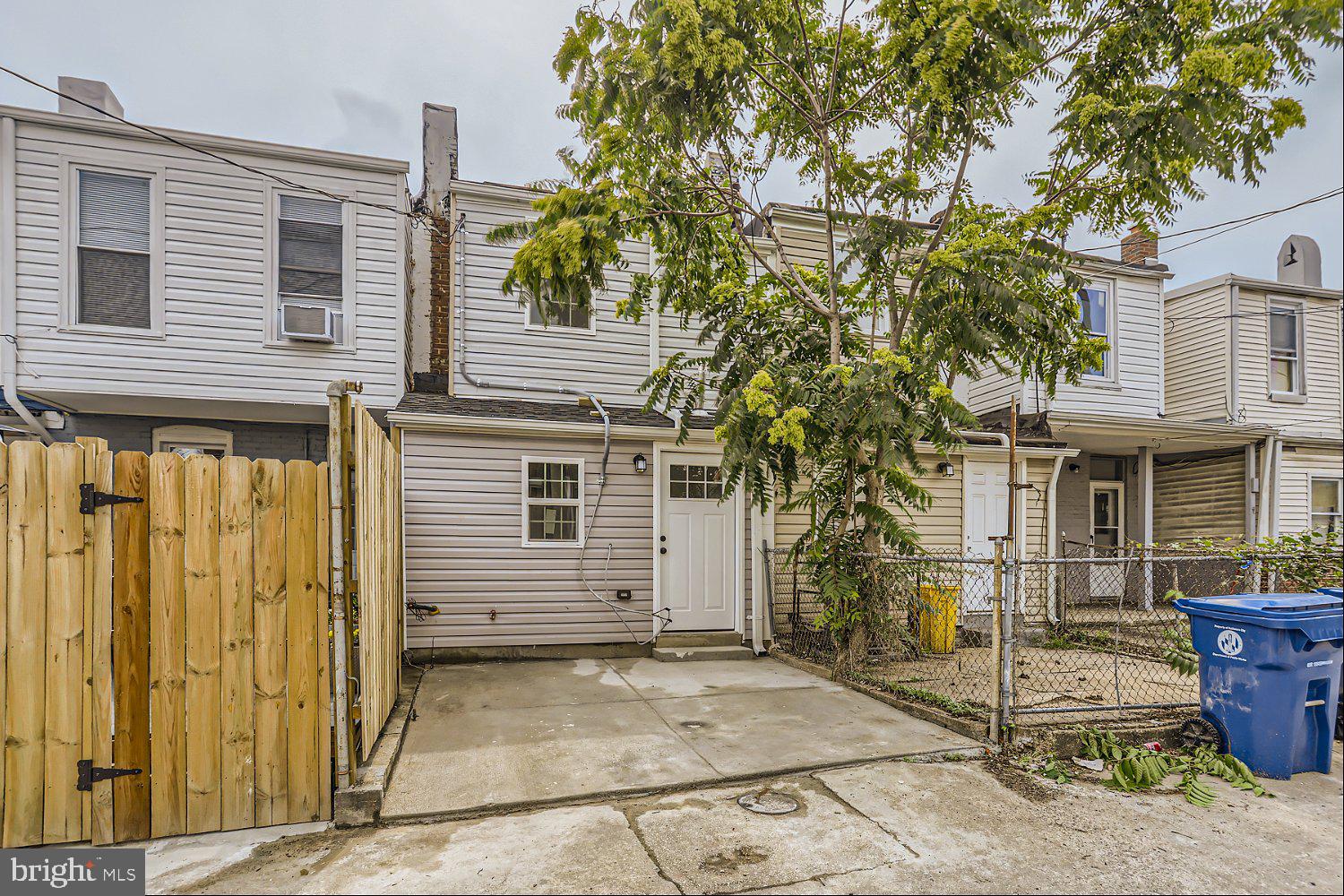 2829 Miles Avenue Baltimore, MD 21211 - Photo 23 of 25 a front view of a house with a tree