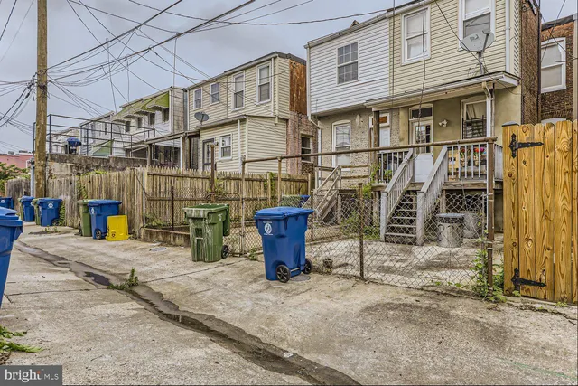a view of a house with wooden fence