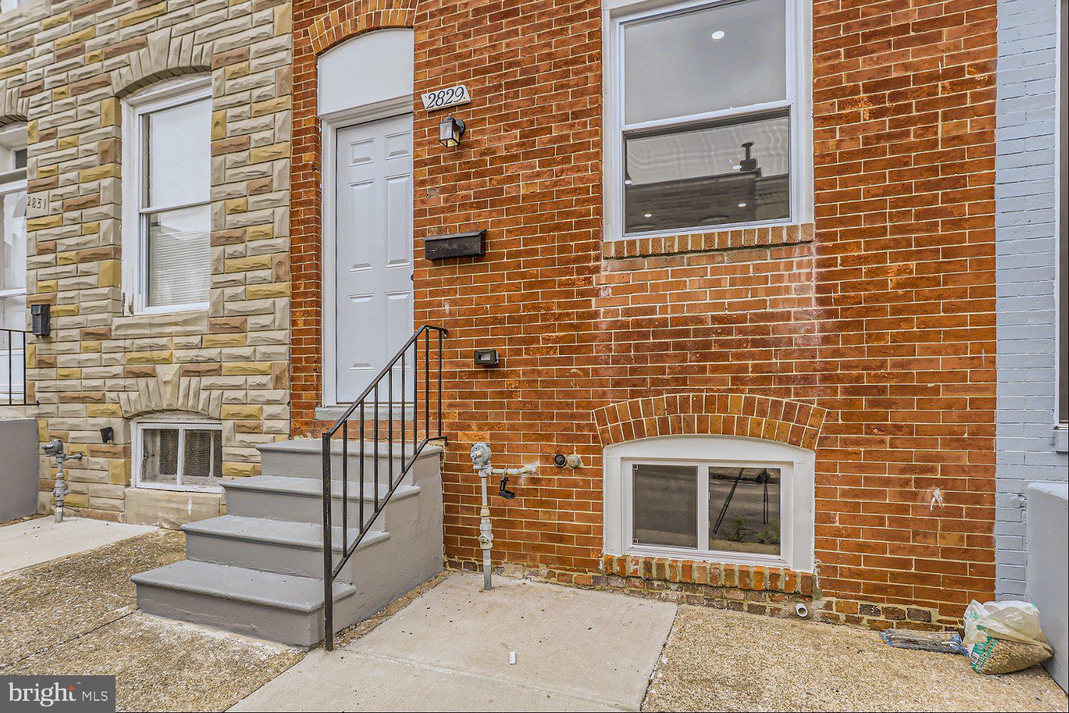 2829 Miles Avenue Baltimore, MD 21211 - Photo 3 of 25 a brick house with a window and a door