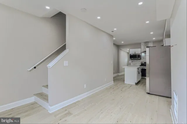 a view of a kitchen with a refrigerator and a sink