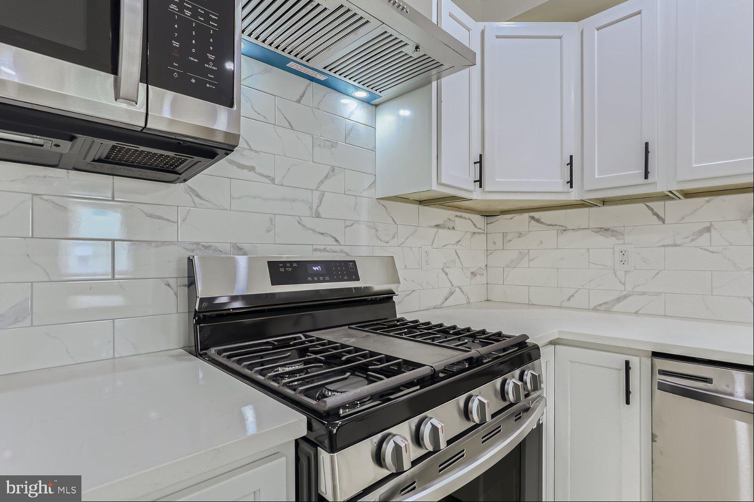 2829 Miles Avenue Baltimore, MD 21211 - Photo 9 of 25 a stove top oven sitting inside of a kitchen