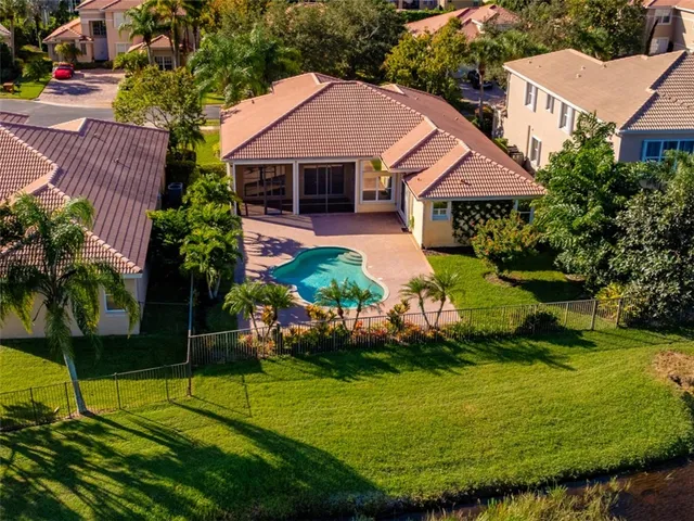 a front view of a house with a yard and potted plants