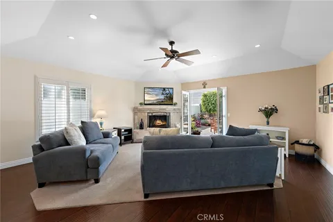a living room with furniture a fireplace and a large window