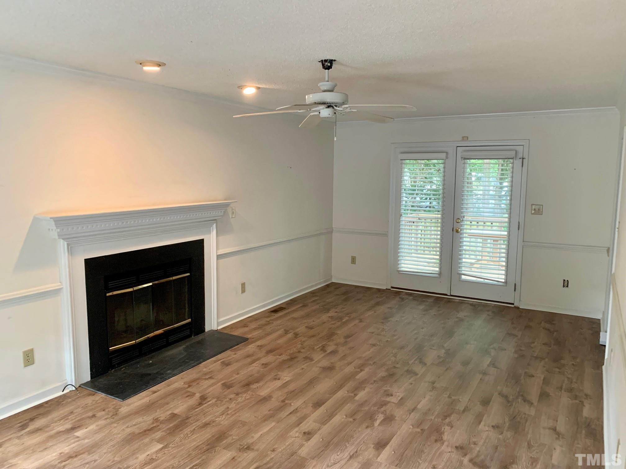 2240 Long And Winding Road Raleigh, NC 27603 - Photo 2 of 10 an empty room with windows and fireplace