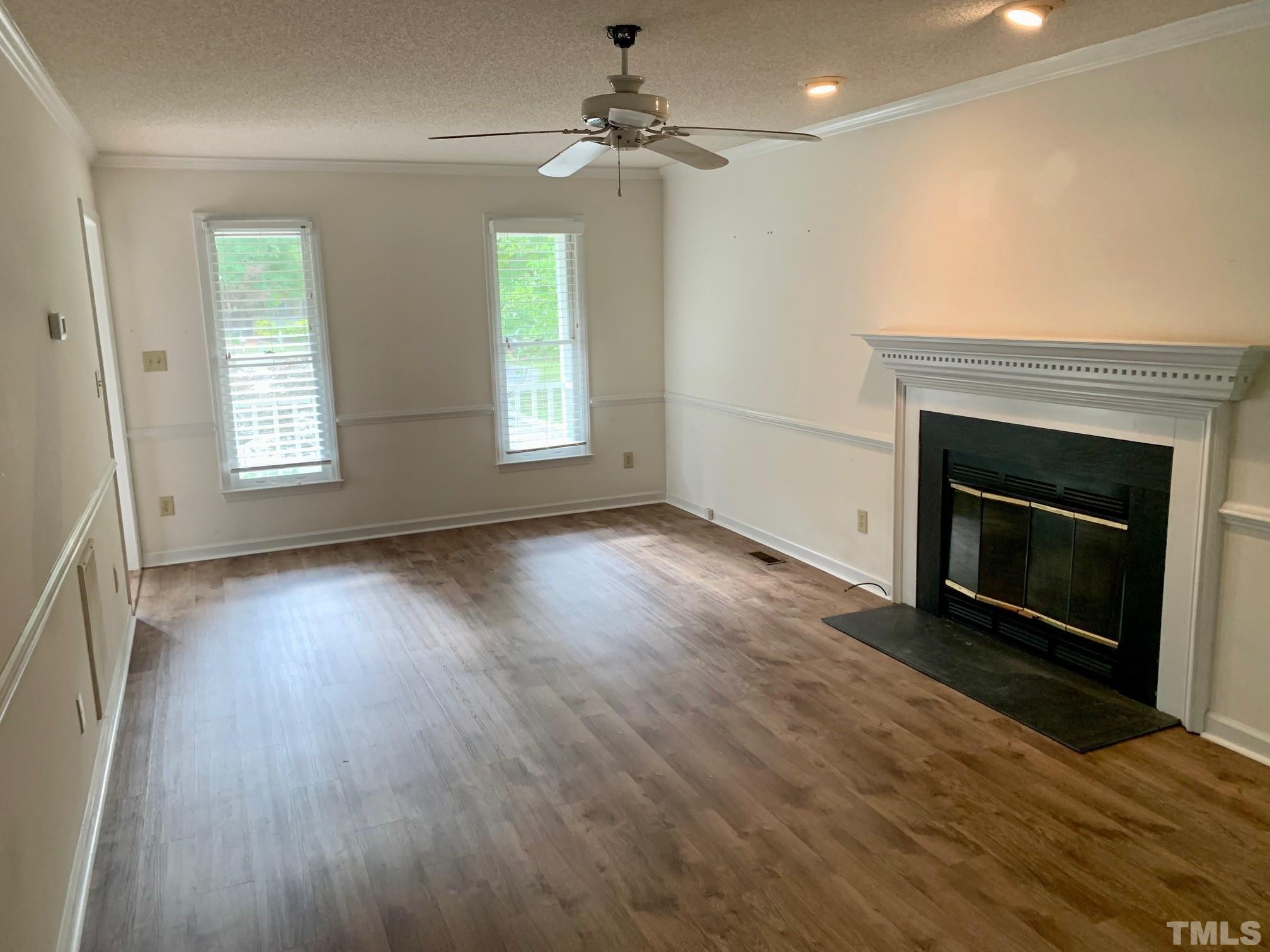 2240 Long And Winding Road Raleigh, NC 27603 - Photo 3 of 10 an empty room with windows and a fireplace