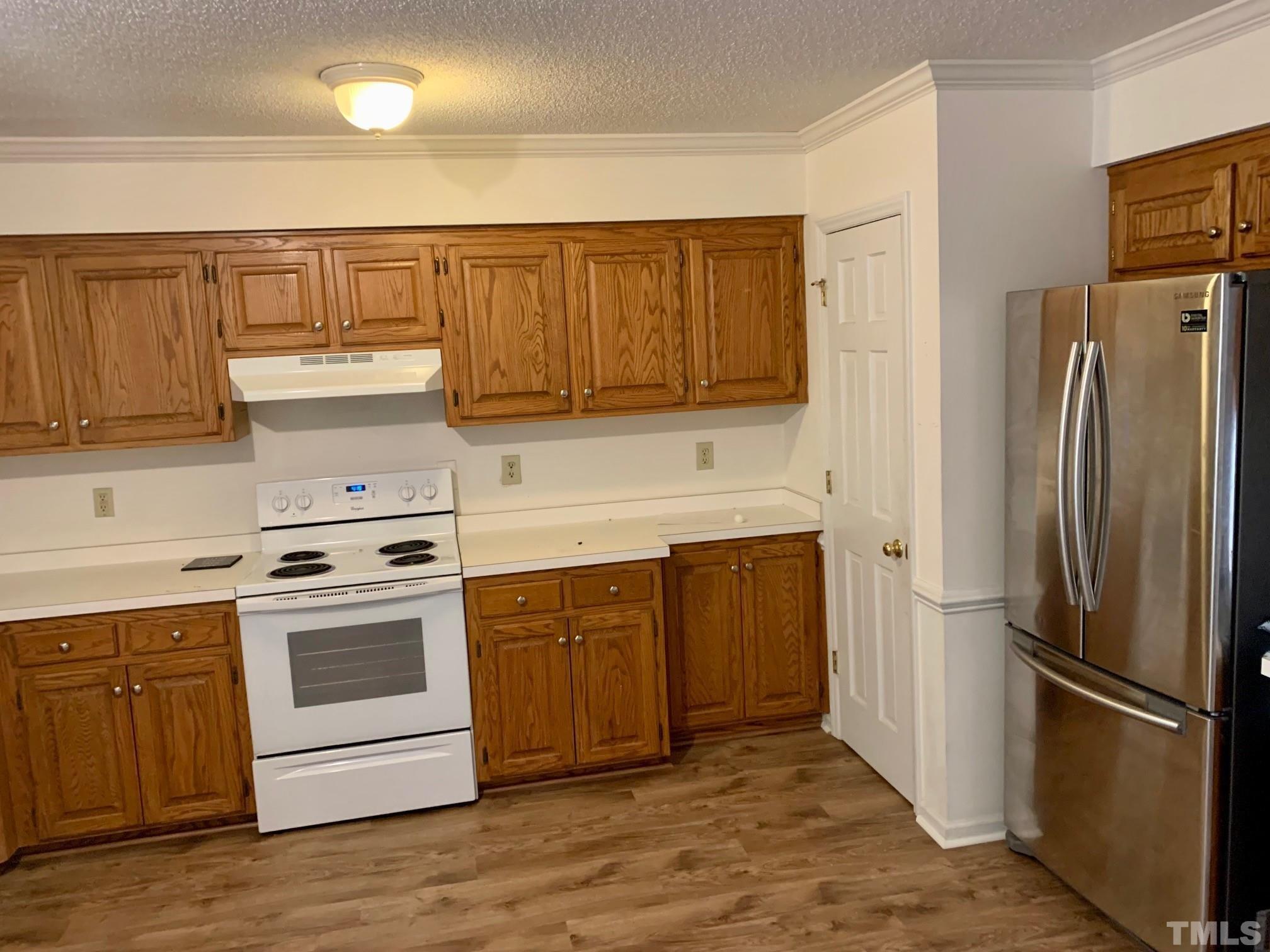 2240 Long And Winding Road Raleigh, NC 27603 - Photo 5 of 10 a kitchen with a refrigerator sink and cabinets