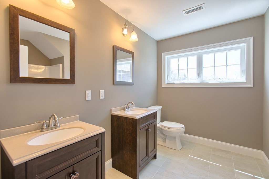 Lot 12 Grapevine Circle Georgetown, MA 01833 - Photo 17 of 27 a bathroom with a toilet sink and mirror