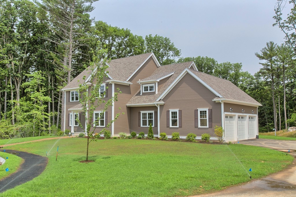 Lot 12 Grapevine Circle Georgetown, MA 01833 - Photo 3 of 27 a front view of a house with a garden