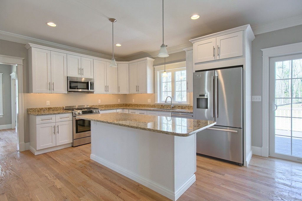 Lot 12 Grapevine Circle Georgetown, MA 01833 - Photo 5 of 27 a kitchen with stainless steel appliances granite countertop a refrigerator a stove a sink and a microwave