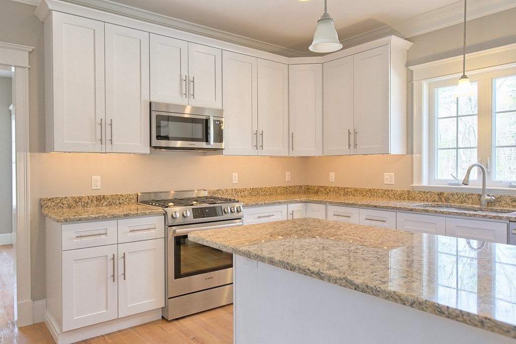 Lot 12 Grapevine Circle Georgetown, MA 01833 - Photo 7 of 27 a kitchen with granite countertop a sink stove and cabinets
