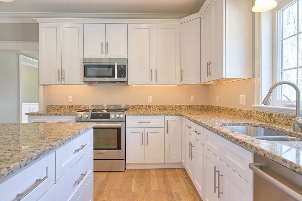 Lot 12 Grapevine Circle Georgetown, MA 01833 - Photo 8 of 27 a kitchen with granite countertop white cabinets and white appliances
