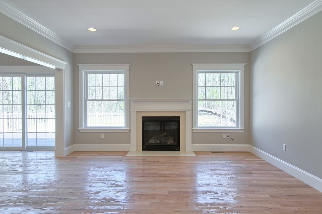 Lot 12 Grapevine Circle Georgetown, MA 01833 - Photo 9 of 27 an empty room with windows and fireplace