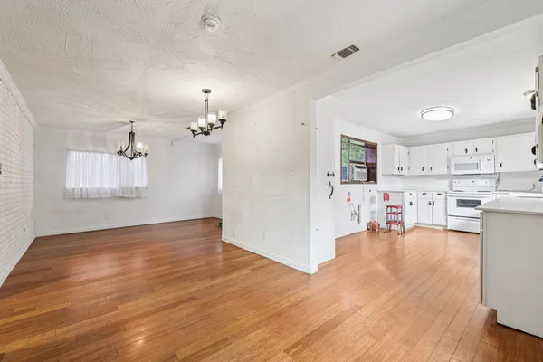 a view of a kitchen and wooden floor