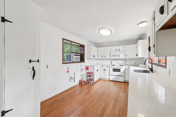 a view of an empty room with white walls