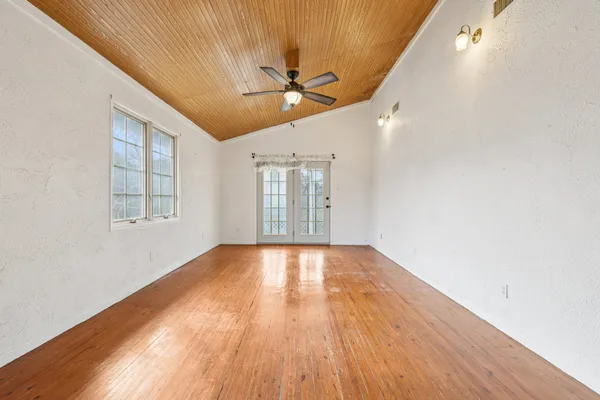 a bathroom with a granite countertop sink mirror and a shower