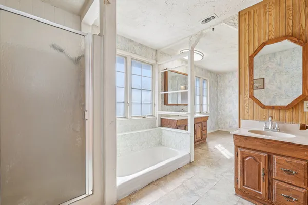 an empty room with a window and a ceiling fan