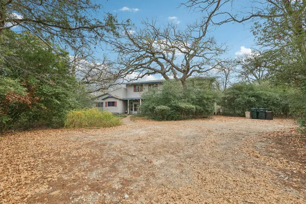 a pathway of a house with a yard