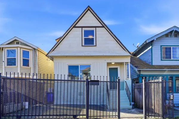a view of a house with wooden fence