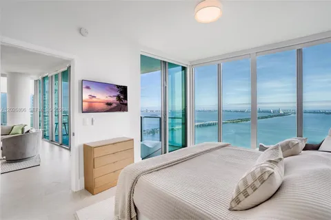 a bedroom with a bed and a lamp