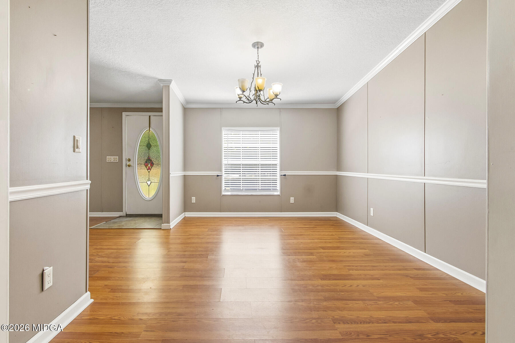 398 Jeffrey Way Forsyth, GA 31029 - Photo 11 of 34 a view of an empty room with window and wooden floor