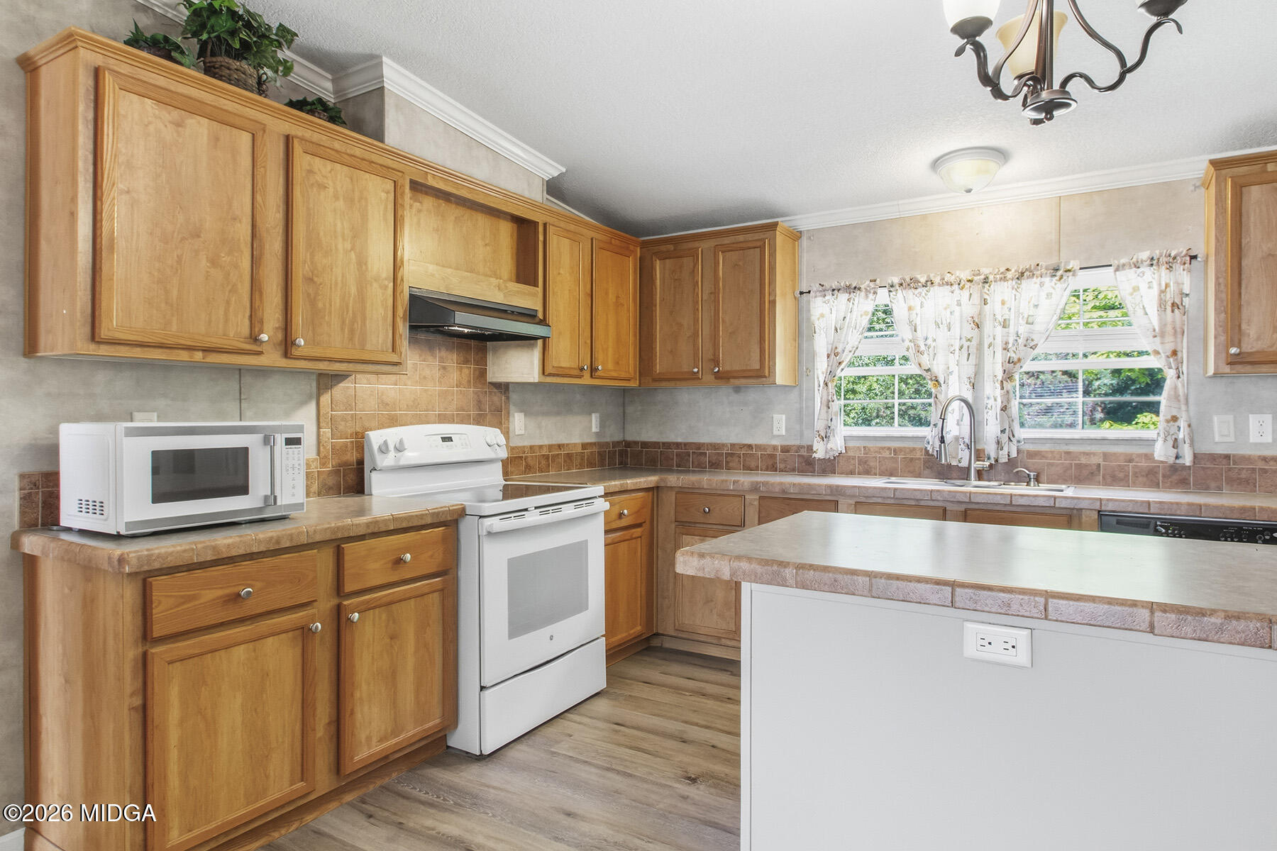 398 Jeffrey Way Forsyth, GA 31029 - Photo 13 of 34 a kitchen with stainless steel appliances granite countertop a stove a sink and a white cabinets with wooden floor