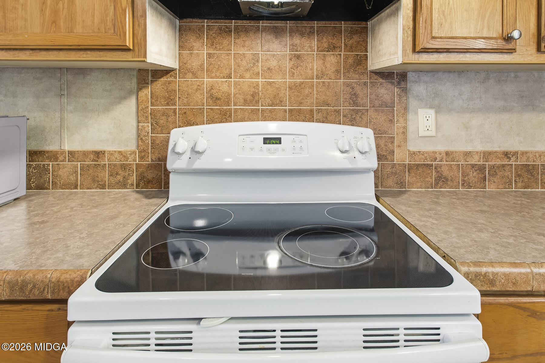 398 Jeffrey Way Forsyth, GA 31029 - Photo 14 of 34 a stove top oven sitting inside of a kitchen