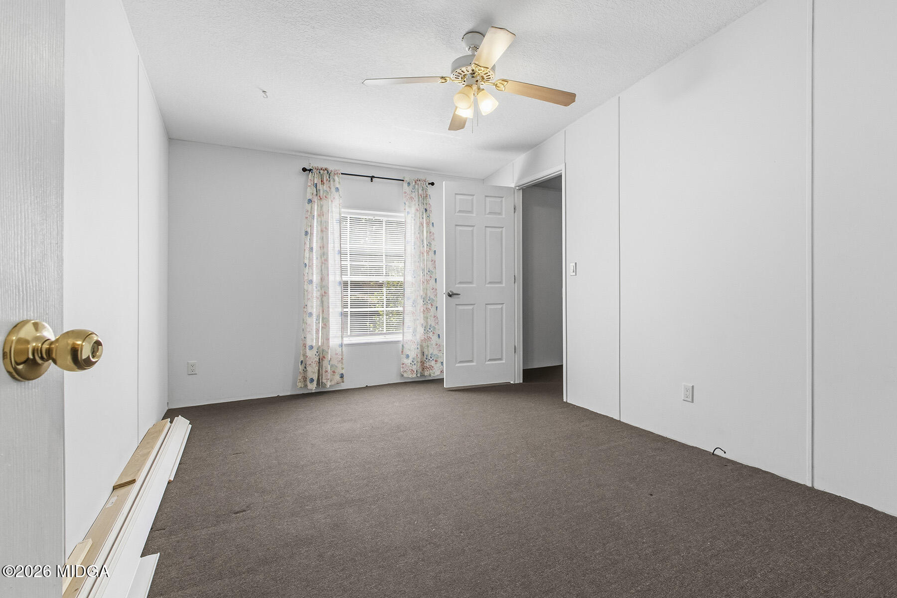 398 Jeffrey Way Forsyth, GA 31029 - Photo 19 of 34 an empty room with windows and fan