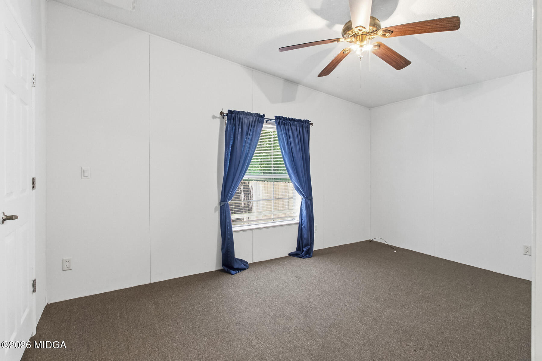 398 Jeffrey Way Forsyth, GA 31029 - Photo 20 of 34 an empty room with chandelier fan and windows