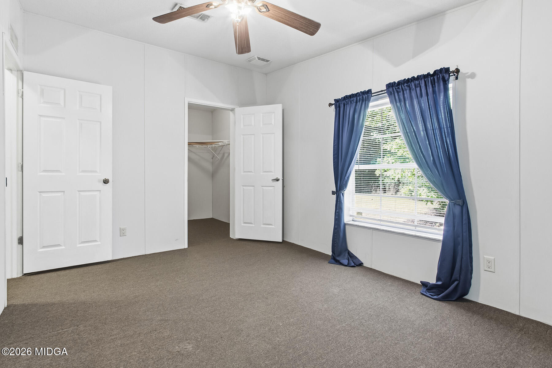 398 Jeffrey Way Forsyth, GA 31029 - Photo 21 of 34 an empty room with windows and closet