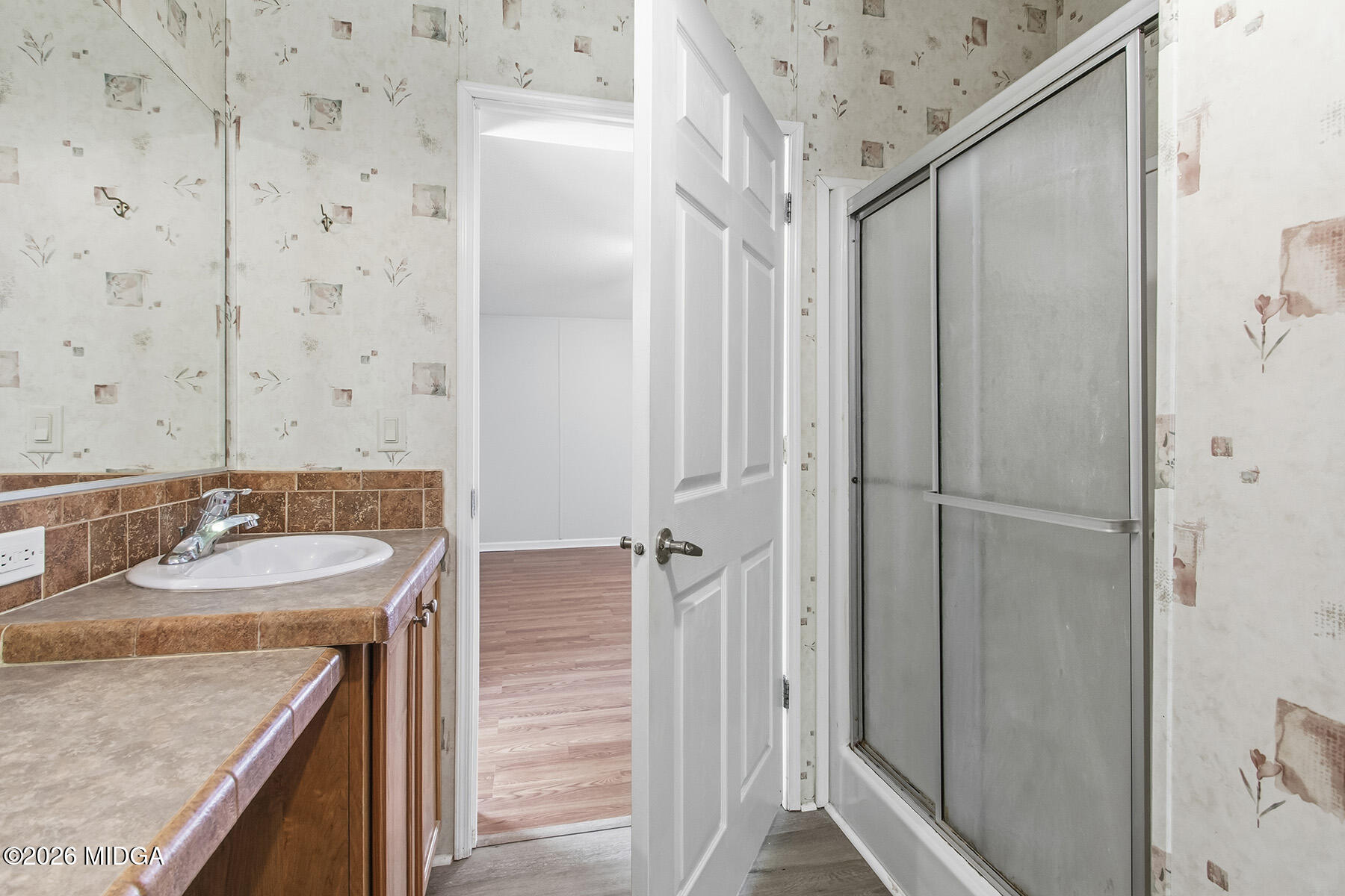 398 Jeffrey Way Forsyth, GA 31029 - Photo 29 of 34 a bathroom with a granite countertop sink and a mirror