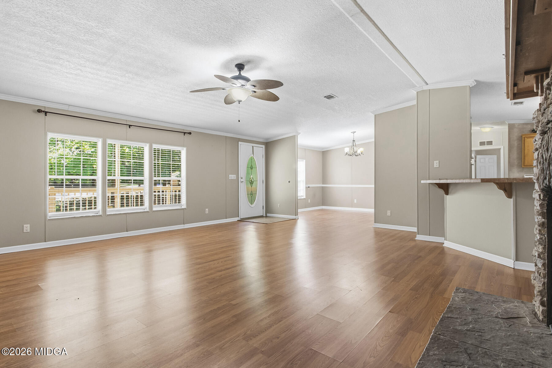 398 Jeffrey Way Forsyth, GA 31029 - Photo 6 of 34 a view of an empty room with a window and wooden floor