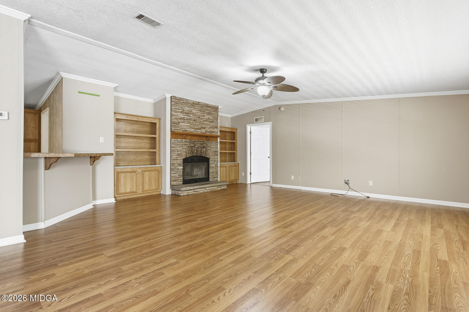 398 Jeffrey Way Forsyth, GA 31029 - Photo 9 of 34 wooden floor in an empty room with a fireplace