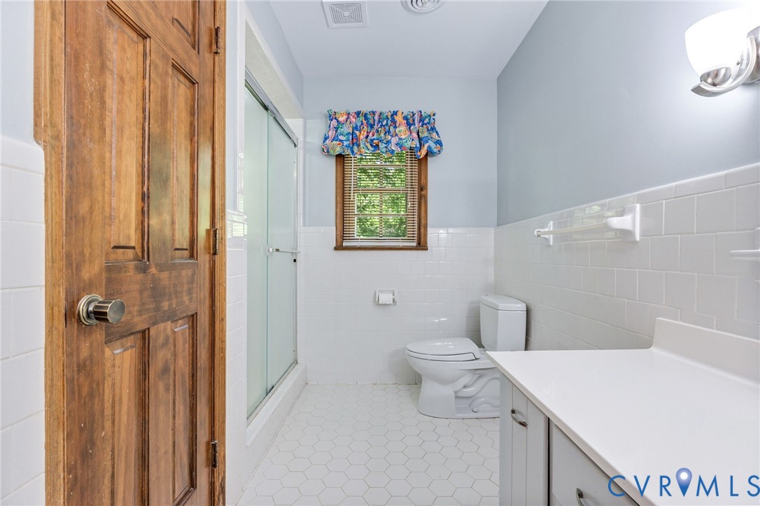 5700 Elfinwood Road Chester, VA 23831 - Photo 26 of 38 a bathroom with a sink a toilet and shower curtain