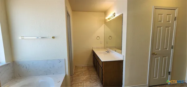 a bathroom with a bathtub sink and toilet