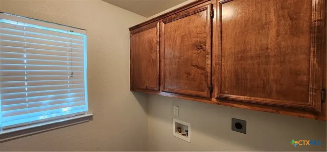 a view of a livingroom with a window and wooden floor