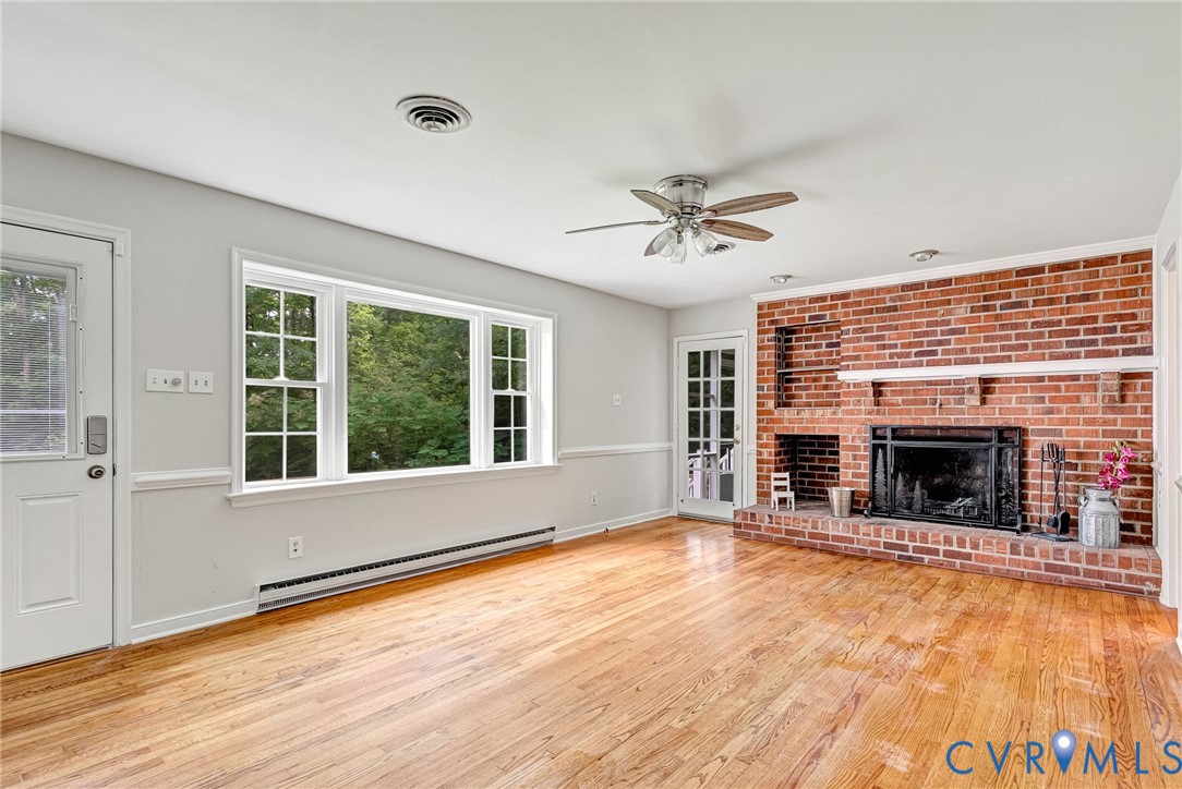 10478 Gould Hill Road Hanover, VA 23069 - Photo 20 of 63 Brick fireplace with a stone hearth, wood-finish f