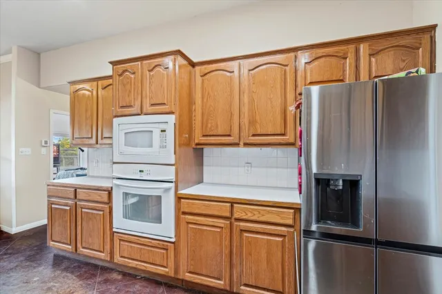 a bathroom with a granite countertop sink a large mirror and a bathtub