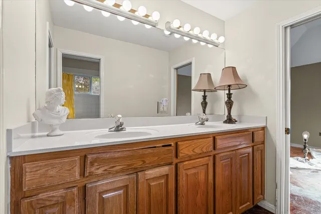 a bathroom with a sink mirror and toilet