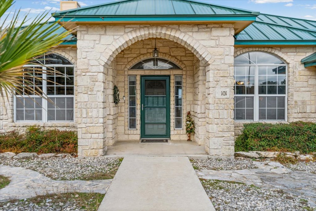101 Valley Vista Road Wimberley, TX 78676 - Photo 2 of 23 The vibrant green entry door welcomes you inside to this cozy home.