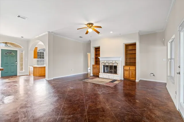 a view of empty room with wooden floor and fireplace