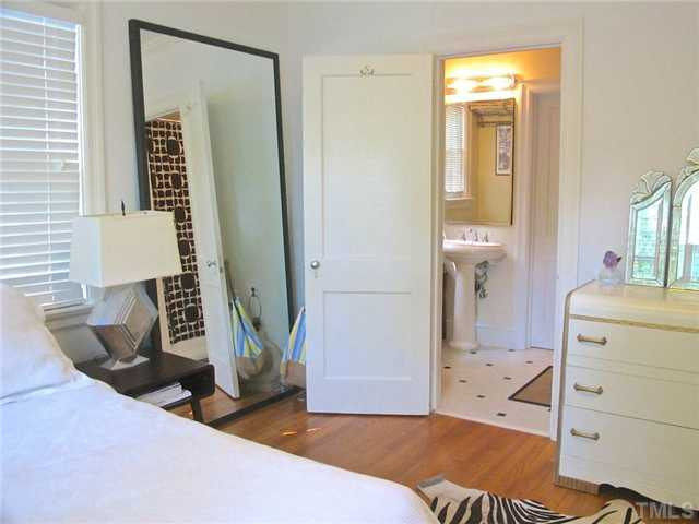 2113 Reaves Drive Raleigh, NC 27608 - Photo 13 of 18 a bedroom with a bed and a mirror