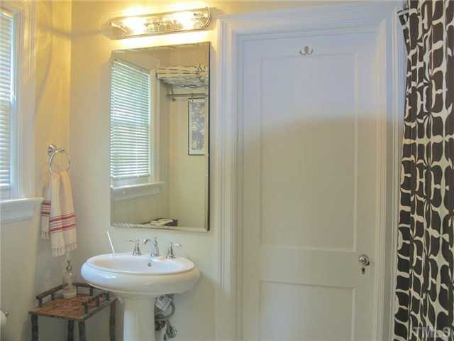 2113 Reaves Drive Raleigh, NC 27608 - Photo 14 of 18 a bathroom with a sink a toilet and shower