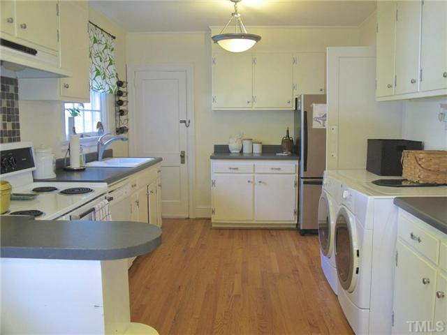 2113 Reaves Drive Raleigh, NC 27608 - Photo 8 of 18 a kitchen with a sink stove and cabinets