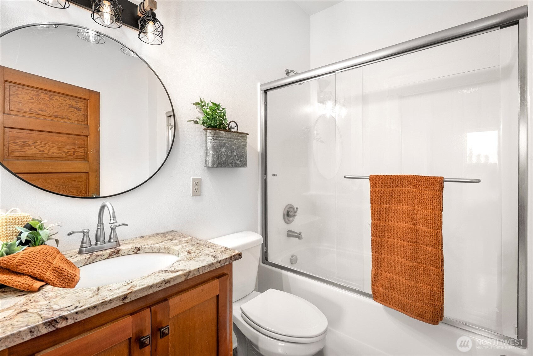 2304 Norman Road Stanwood, WA 98292 - Photo 19 of 39 a bathroom with a granite countertop sink toilet a mirror and shower