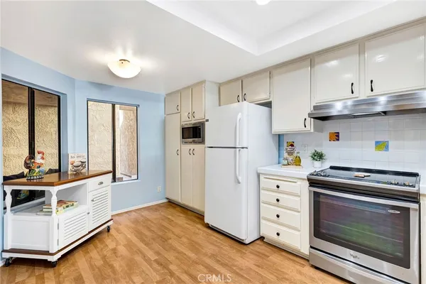 a kitchen with cabinets and stainless steel appliances