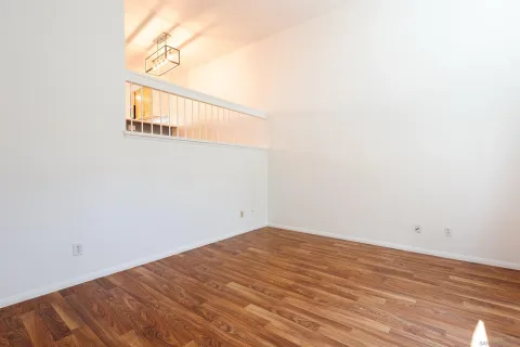 a view of a room with wooden floor and a fireplace